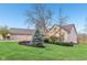 Well-maintained home with landscaping features, including trees and shrubs, enhancing curb appeal at 168 Yorkshire W Blvd, Cumberland, IN 46229