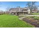 The backyard features a multi-level deck, hot tub, and lush lawn for outdoor enjoyment at 168 Yorkshire W Blvd, Cumberland, IN 46229