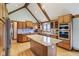 Bright kitchen features an island, wood cabinets, stainless steel appliances, and hardwood floors at 168 Yorkshire W Blvd, Cumberland, IN 46229
