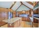 Bright kitchen features an island, wood cabinets, stainless steel appliances, and hardwood floors at 168 Yorkshire W Blvd, Cumberland, IN 46229