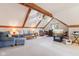 Open-concept living space with carpet, enhanced by exposed wooden beams, and inviting furnishings at 168 Yorkshire W Blvd, Cumberland, IN 46229