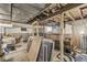 Unfinished basement featuring exposed wooden beams and partial wood paneling at 1710 S Butler Ave, Indianapolis, IN 46203