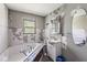 Bathroom features a soaking tub, single sink vanity, and medicine cabinet at 1710 S Butler Ave, Indianapolis, IN 46203