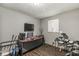 Bedroom with wood floors, a large window, and neutral gray walls at 1710 S Butler Ave, Indianapolis, IN 46203