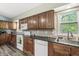 Bright kitchen featuring wooden cabinetry, granite countertops, and modern appliances at 1710 S Butler Ave, Indianapolis, IN 46203