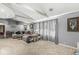 Spacious living room with comfortable seating and large windows, neutral paint and carpet at 1710 S Butler Ave, Indianapolis, IN 46203