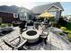 A backyard patio featuring a seating area with a fire pit, an outdoor dining area, and landscaping at 18756 Brookston Ln, Noblesville, IN 46062