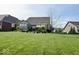 Manicured backyard featuring ample green space and a patio seating area, perfect for relaxation at 18756 Brookston Ln, Noblesville, IN 46062
