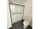 This bathroom has a sleek glass-door shower and modern black fixtures on the shower door at 18756 Brookston Ln, Noblesville, IN 46062