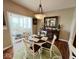 Cozy dining area showcases hardwood floors, a stylish light fixture, and views into the bright and airy living space at 18756 Brookston Ln, Noblesville, IN 46062