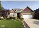 Charming brick home with a well-manicured lawn, landscaping and a two-car garage in a suburban neighborhood at 18756 Brookston Ln, Noblesville, IN 46062