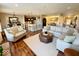 Open-concept living room boasts hardwood floors and neutral decor, seamlessly flowing into the kitchen and dining area at 18756 Brookston Ln, Noblesville, IN 46062