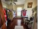 Bedroom space with hardwood floors, a ceiling fan, and clothing racks at 23 N West St, Shelbyville, IN 46176