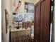 Walk-in closet featuring decorative wall art, storage dresser, and an adjacent door at 23 N West St, Shelbyville, IN 46176