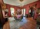 Cozy dining room featuring a round table, chandelier lighting, and rich red walls at 23 N West St, Shelbyville, IN 46176