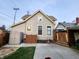 View of the home's exterior, featuring a cozy patio, wood fence, shed, and manicured lawn at 23 N West St, Shelbyville, IN 46176
