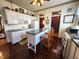 Open kitchen featuring matching appliances, white cabinetry and a center island at 23 N West St, Shelbyville, IN 46176