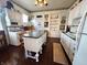 Updated kitchen featuring white cabinetry, stainless appliances and island with seating at 23 N West St, Shelbyville, IN 46176