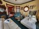 Spacious living room with hardwood trim, ornate windows, fireplace, and comfortable seating at 23 N West St, Shelbyville, IN 46176
