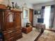 This bright bedroom features a patterned rug, wood furniture and accent decorations at 23 N West St, Shelbyville, IN 46176