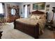 A well-lit primary bedroom showcasing carpeted floors, ample natural light, and a coordinating furniture set at 23 N West St, Shelbyville, IN 46176