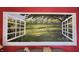 Wall art with an open window view of a sunny meadow and colorful trees at 23 N West St, Shelbyville, IN 46176