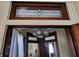 Decorative transom window with art glass and dark wood trim at 23 N West St, Shelbyville, IN 46176