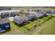 Aerial view of houses with green lawns, a tranquil pond, and community amenities at 2428 S Stonehill Way, New Palestine, IN 46163