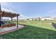 Spacious backyard featuring a deck with pergola, swing, dining area, and a playground at 2428 S Stonehill Way, New Palestine, IN 46163