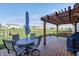 Backyard deck features a pergola, outdoor seating, BBQ grill, and views of the fenced yard at 2428 S Stonehill Way, New Palestine, IN 46163