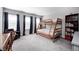 Spacious bedroom featuring large windows, carpet, and a wooden bunkbed at 2428 S Stonehill Way, New Palestine, IN 46163
