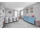 Bright bedroom featuring neutral walls, carpet, a blue dresser and plentiful natural light at 2428 S Stonehill Way, New Palestine, IN 46163