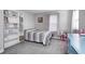 Cozy bedroom with neutral walls, carpet, a gray bed and a white bookshelf at 2428 S Stonehill Way, New Palestine, IN 46163