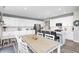Bright kitchen with white cabinets, stainless steel appliances, and dining area at 2428 S Stonehill Way, New Palestine, IN 46163
