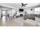 Cozy living room featuring a fireplace, large sectional, and modern ceiling fan at 2428 S Stonehill Way, New Palestine, IN 46163