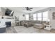 Bright living room with fireplace, large windows, and comfortable sectional sofa at 2428 S Stonehill Way, New Palestine, IN 46163