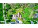 A bird's-eye view of a home with spacious surroundings, mature trees, and a long driveway at 260 17Th St, Columbus, IN 47201