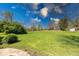 Expansive backyard featuring lush green grass and mature trees, perfect for outdoor activities and relaxation at 260 17Th St, Columbus, IN 47201