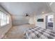 Cozy bedroom features a bed, carpeted floors and natural lighting with easy access to an adjacent bathroom at 260 17Th St, Columbus, IN 47201