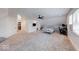 Expansive bedroom with neutral carpet and wood paneled ceilings featuring a bed, desk and lots of open space at 260 17Th St, Columbus, IN 47201