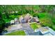 An exterior elevation view of a home with stone facade, attached garage, long driveway and spacious lawn at 260 17Th St, Columbus, IN 47201