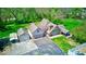 Exterior elevation showcasing a home with a lush lawn, garage, and detached shed with ample parking space at 260 17Th St, Columbus, IN 47201