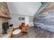 Inviting living room with stone fireplace, wood accent wall and hardwood floors at 260 17Th St, Columbus, IN 47201