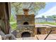 Outdoor kitchen with a stone pizza oven and counter space at 260 17Th St, Columbus, IN 47201