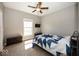 Cozy bedroom featuring a ceiling fan, natural light, and carpet flooring at 2803 Wild Orchid Way, Columbus, IN 47201