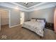 Comfortable main bedroom featuring tray ceilings, neutral colors, and walk-in closet at 2803 Wild Orchid Way, Columbus, IN 47201