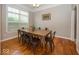 Bright dining room with large windows, wood floors, and modern lighting at 2803 Wild Orchid Way, Columbus, IN 47201