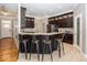 Modern kitchen with dark wood cabinets, granite countertops, and bar seating at 2803 Wild Orchid Way, Columbus, IN 47201