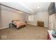 Cozy basement bedroom with a comfortable bed, dresser, and a window at 2803 Wild Orchid Way, Columbus, IN 47201