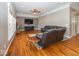Spacious living room with wood floors, tray ceiling, and comfortable seating at 2803 Wild Orchid Way, Columbus, IN 47201
